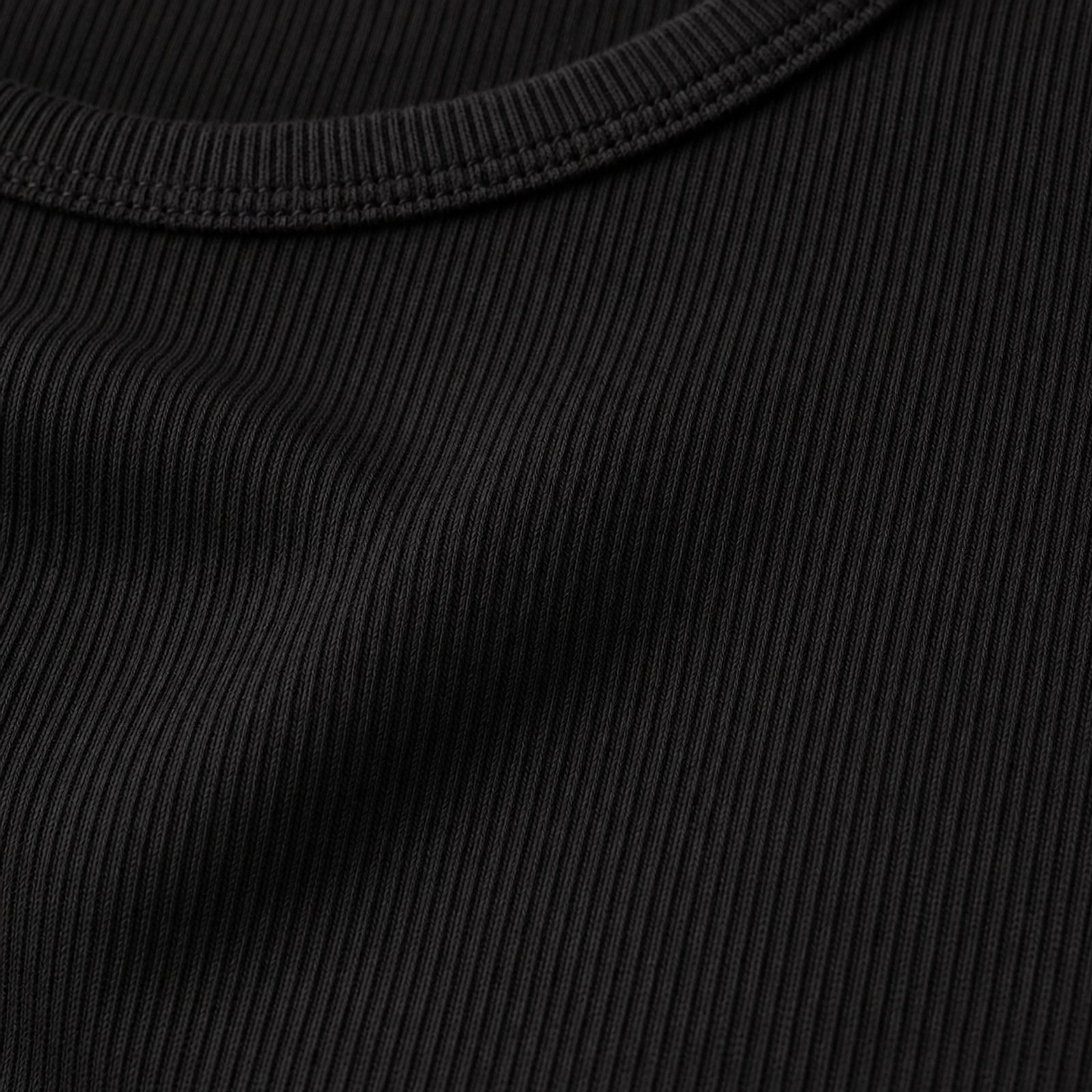 Close-up of black fine rib tank neckline and fabric texture